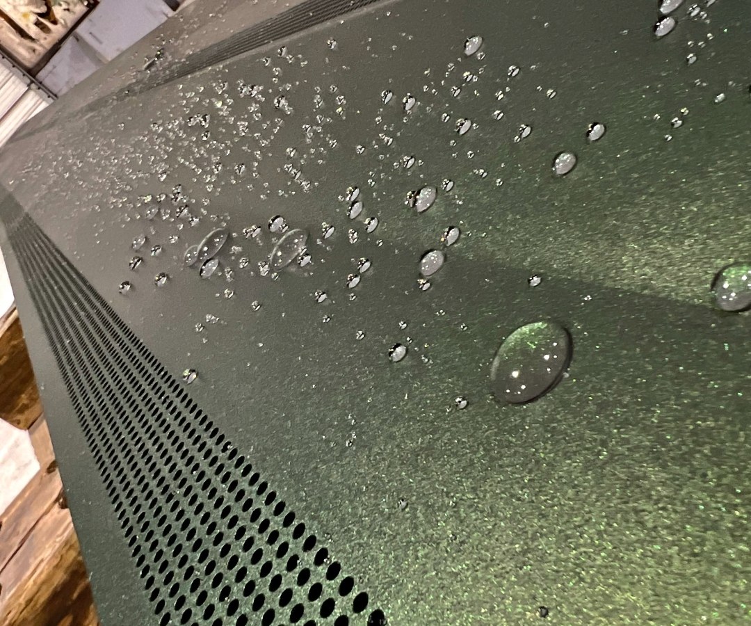 AEGIS coated diffuser with water beading on the fluoropolymer surface, clean perforations