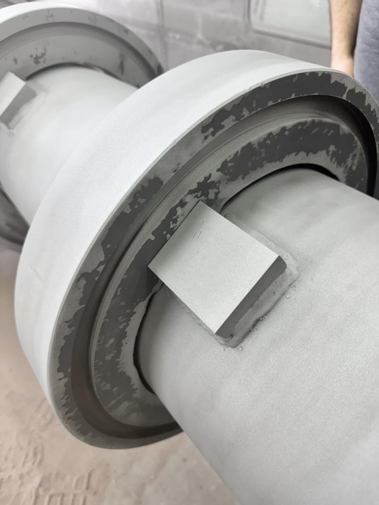 Roll surface after traditional grit blasting showing degradation and incomplete coverage