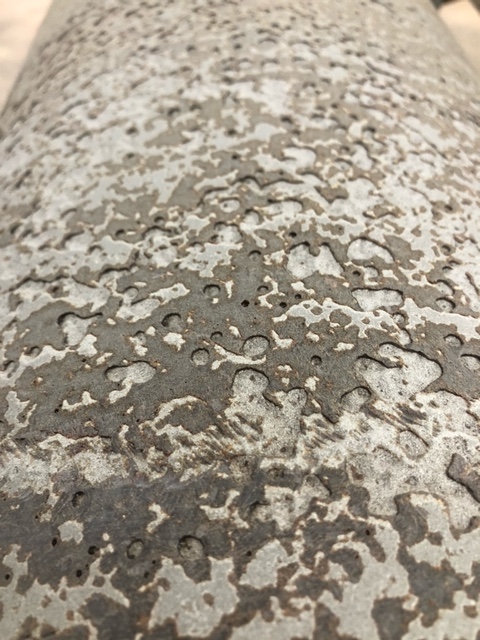 Heavy pitting corrosion damage on an uncoated industrial cylindrical part, the failure mode AEGIS prevents