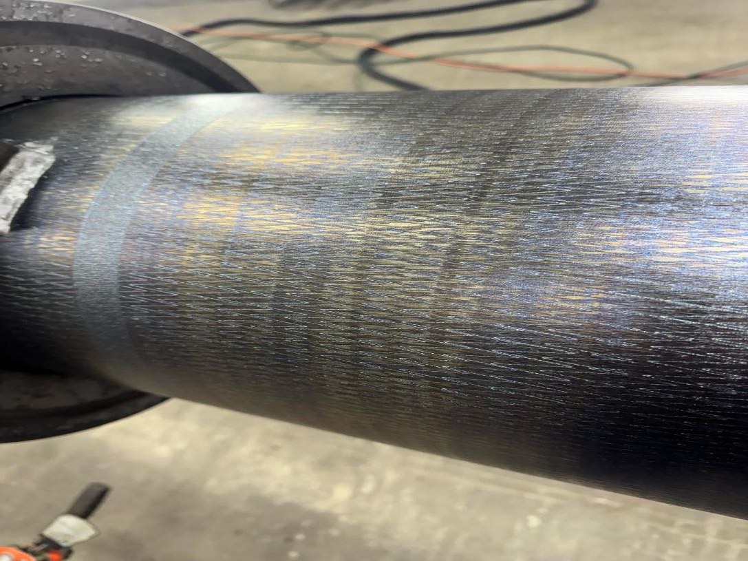 Roll surface after AEGIS precision energy cleaning showing uniform corona-treated finish
